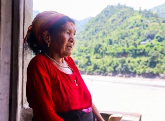 Nanimaya Senchuri looking at what is left after the devastating floods destroyed farmlands in her village